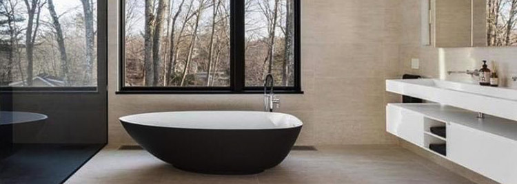 Ultra modern bath with uniquely shaped, free-standing tub and floating vanity.